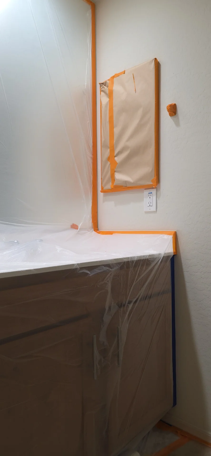 Bathroom vanity and mirror masked before an interior repaint in Surprise, AZ