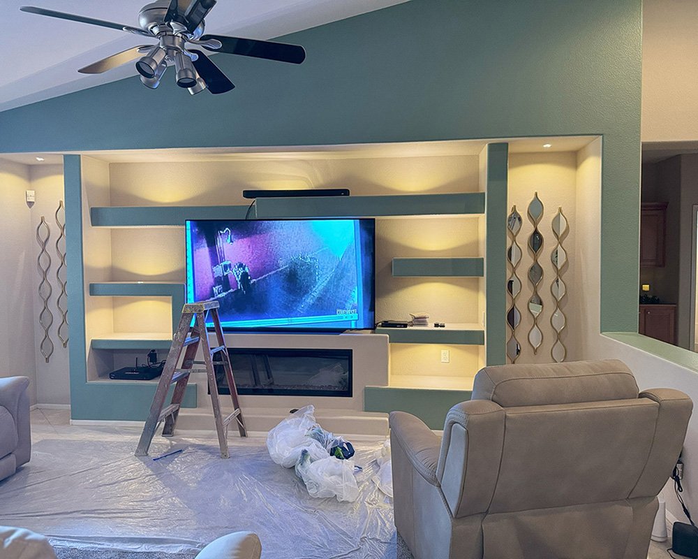 Interior painting with custom wall accents and entertainment center, showcasing Desert Mesa Painting craftsmanship.